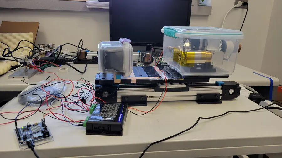 The same system, on the bench. Source, detector, and motion control breadboarded before anything went into the machine.