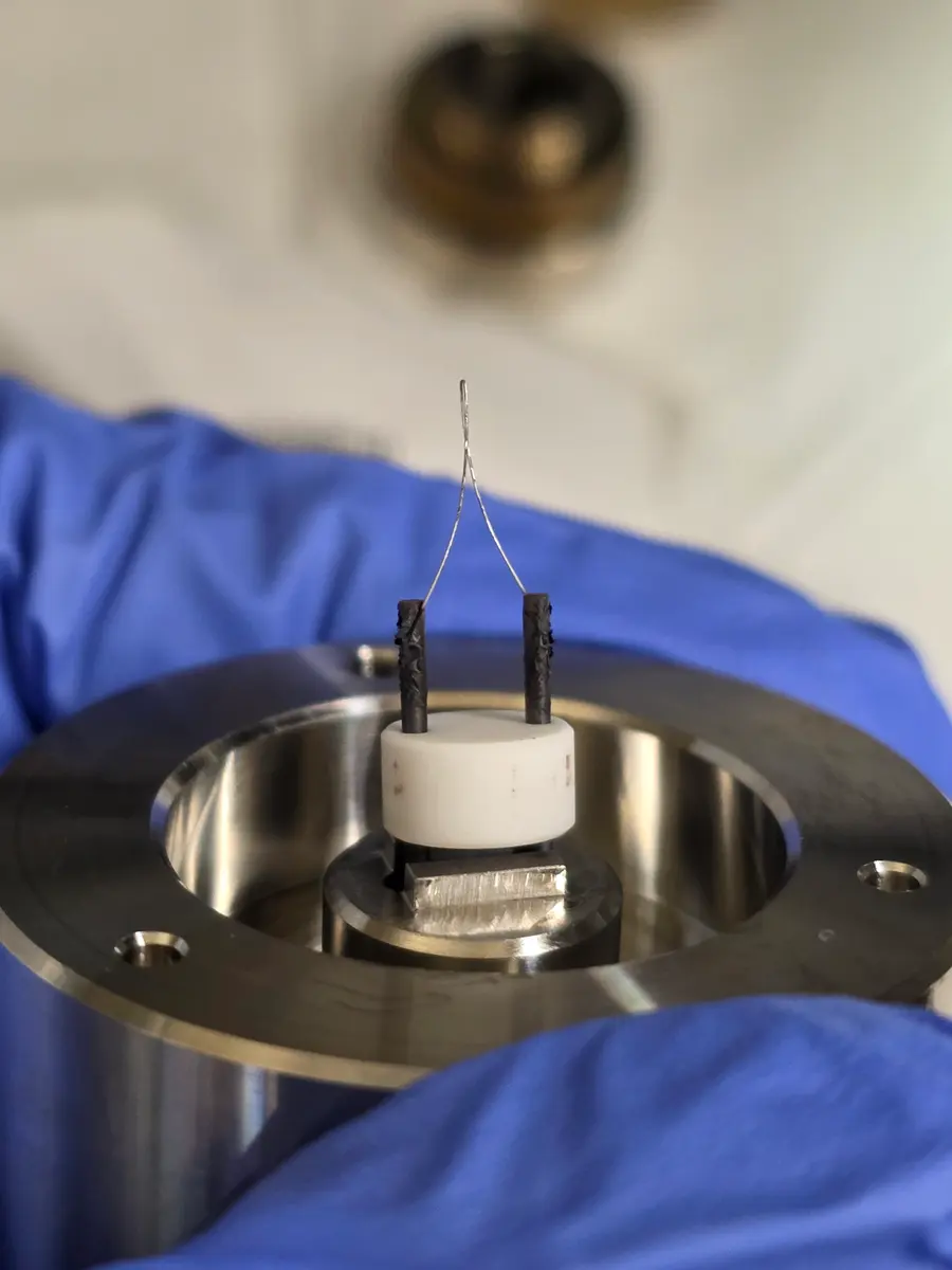 Troubleshooting the electron source. The hairpin tungsten filament that supplies electrons to the RHEED gun by thermionic emission. Arcing across its metal contacts had burned it out early.